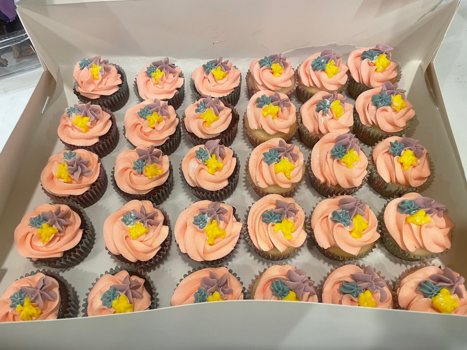 A box of flower cupcakes